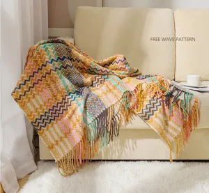 Woven chenille sofa throw blanket with fringe, elegant boho wave pattern detail shot.
