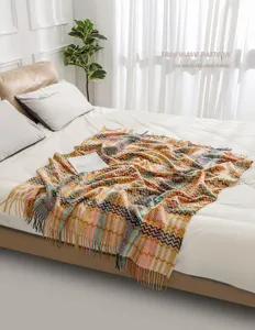 Chenille throw blanket detail showcasing colorful zigzag herringbone bohemian knit pattern texture.