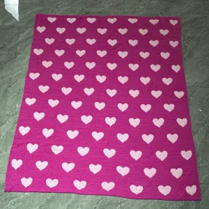 Valentine pink heart fleece blanket detail shot, cozy knitted microfiber gift throw.