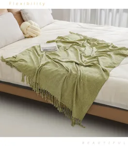 Cozy green knitted fringe throw blanket detail, soft home textile texture for room decor.