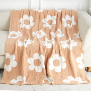 Cozy daisy pattern microfiber blanket detail view, soft knitted throw for living room sofa.
