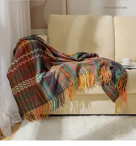 Detailed view of the woven chenille blanket featuring a vibrant boho wave herringbone pattern.