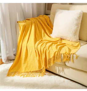Yellow knitted throw blanket detail, soft fringe design, cozy home decor sofa blanket.
