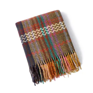 Bohemian woven chenille throw blanket with chevron pattern and fringe for cozy living room sofa.