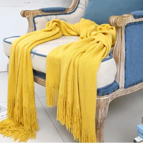 Gelbe geflochtene Wohndecke mit Fransen, kuschelige Sofadecke für gemütliche Wohnzimmer.