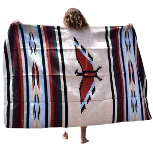 Mexican woven blanket with traditional thunderbird and Aztec stripe patterns for beach and home decor.