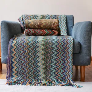 Bohemian knitted throw blanket with colorful zigzag pattern and tassels for sofa living room.