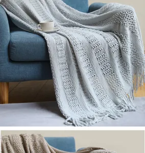 Douce couverture en tricot style nordique avec motif ajouré et franges pour canapé et lit.
