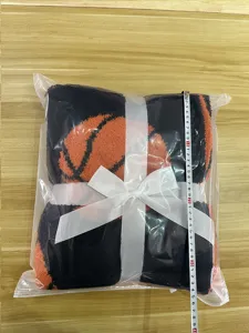 Cozy basketball pattern plush blanket with white ribbon bow, soft and warm throw.