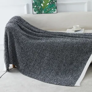 Textured fleece blanket close-up detail, soft cozy throw blanket draped on modern sofa decor.