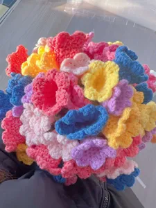 Handmade crochet colorful flower blanket, creative floral bouquet gift design for home decor.
