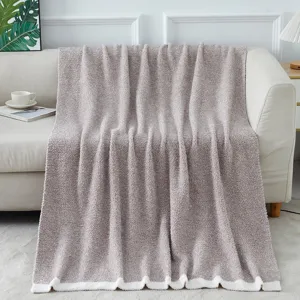 Cozy knitted fleece blanket draped on sofa, soft textured home decor throw for living room.