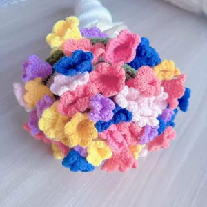 Handmade crochet flower bouquet detail view, colorful wool knit floral arrangement gift decor.