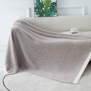 Cozy knitted throw blanket detail on sofa, soft plush warm blanket for home living room decor.
