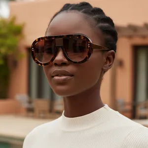 Oversized tortoise shell shield sunglasses for women, retro oval frame with metal rivets.