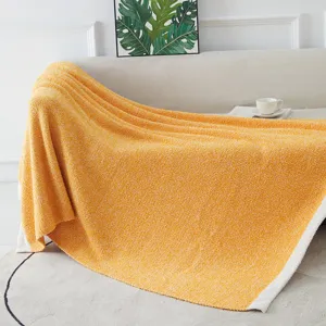 Soft knitted yellow throw blanket for cozy home decor living room sofa styling detailed shot