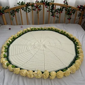 Handcrafted circular crochet blanket with yellow floral edge and green trim for cozy room decor.