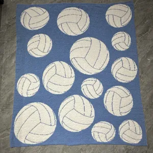 Detailed view of the soft knit throw blanket featuring white volleyball patterns.