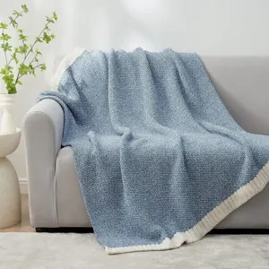 Detailed view of the cozy blue knitted throw blanket showcasing soft texture and warm design.