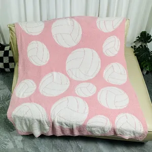 Cozy pink fuzzy throw blanket featuring cute white volleyball patterns, soft and warm for couch bed.