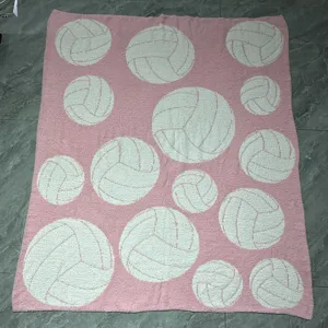 Pink feather yarn plush blanket featuring cute white volleyball patterns, cozy soft throw for bed.