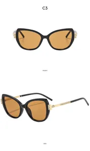 Modische Luxus Strass Katzenauge Sonnenbrille für Damen, schwarzer Rahmen mit braunen UV Gläsern.