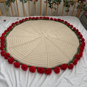 Handmade crochet round blanket detail view with red rose edge decoration for cozy home decor.