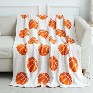 Cozy white plush throw blanket featuring vibrant orange basketball pattern for home decor.