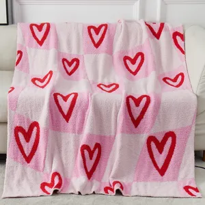 Pink checkered plush blanket with red hearts, cozy velvet throw for Valentine's Day decor.