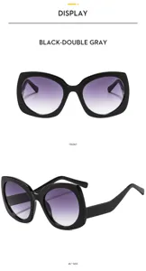 Vista detallada de gafas de sol cat-eye grandes con lentes grises degradadas muy elegantes.