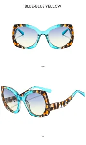 Detalle de gafas de sol cat-eye con montura azul y cristales degradados elegantes.