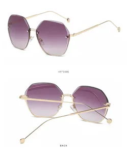 Gafas de sol degradadas poligonales sin montura elegantes con patillas metálicas doradas.