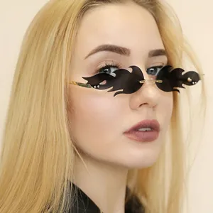 Close-up view of trendy rimless flame sunglasses worn by a model, featuring unique dark lenses.