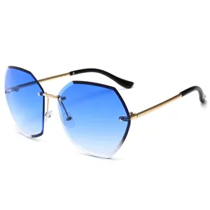 Fashionable oversized gradient blue rimless sunglasses with chic metal temples for women.