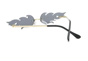 Detail view of trendy rimless flame sunglasses with unique grey lenses and gold metal frame.