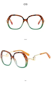 Detailed view of oversized gradient glasses with pearl decor temples chic design.