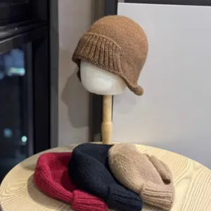 Detailed view of the knitted basin hat showing the folded multi-color display and soft texture.
