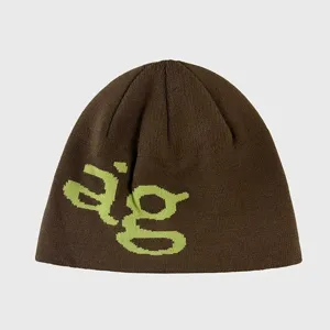 Close-up view of the knitted beanie showcasing the contrast lime green letter graphic.