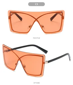 Gafas de sol de una pieza sin montura grandes con lentes naranjas para estilo urbano.