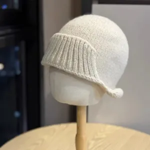 Chic irregular knitted fisherman hat detail, cozy solid color winter basin hat soft texture.