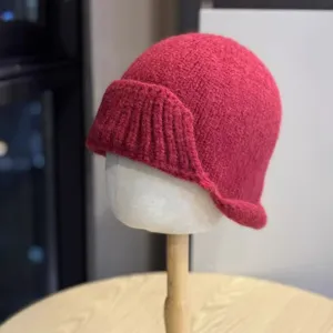 Detailed view of the rose red knitted fisherman hat, featuring irregular rolled brim.
