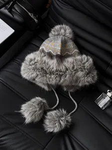 Winter warm knitted faux fur bomber hat with fluffy pom-poms, cozy ethnic jacquard detail.
