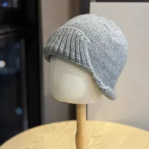 Grey knitted bucket hat detail, winter warm retro irregular rolled brim fisherman cap design.