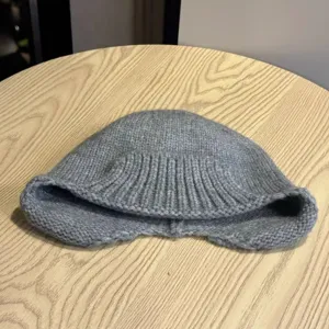 Grey knitted irregular fisherman hat detail view, autumn winter cute retro style basin hat.
