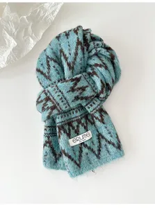 Close-up detail view of a stylish blue and brown fair isle knit scarf for winter.