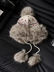 Winter warm knit trapper hat with ethnic jacquard pattern and soft faux fur earflaps and pom poms.