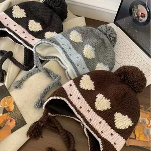 Winter warm knit ear flap hat with pom pom and cute heart jacquard pattern for women.