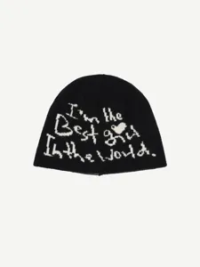 Detailed view of the black knitted beanie featuring woven slogan and heart pattern style.