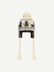 Detailed view of winter knit earflap beanie hat with Nordic jacquard pattern and fluffy pom pom.