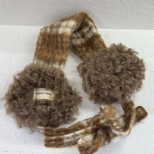 Detailed close-up of cozy brown plaid plush earmuffs, fluffy texture and sweet ties.